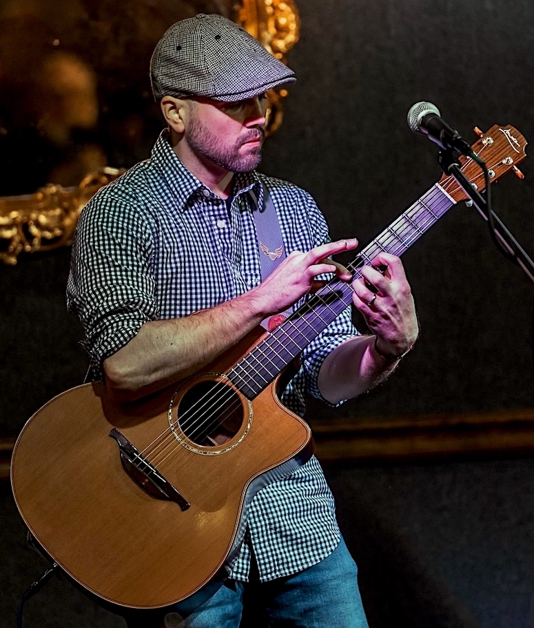 Ty in the studio, photographed alongside a vintage Edison recording horn and his guitar